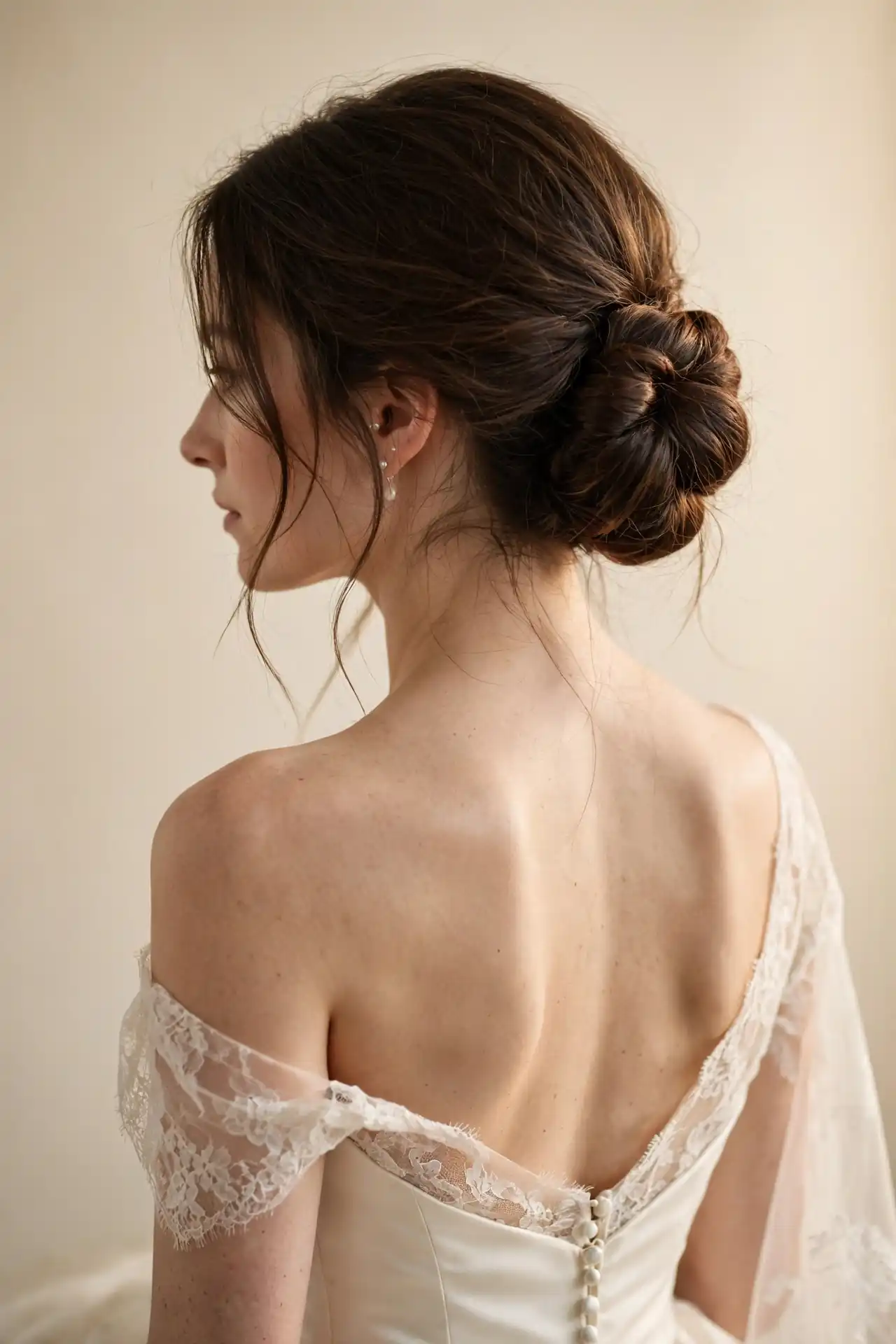 FEATURE / HERO IMAGE Editorial bridal beauty portrait of a bride with very long flowing brunette hair styled in an elegant low chignon with a few soft face-framing pieces, three-quarter angle with her chin slightly lifted, wearing a sophisticated ivory wedding gown with delicate lace detailing, a long cathedral veil anchored beneath the low knot, warm natural window light creating a luminous glow around the hair, softly blurred elegant wedding venue in the background, realistic individual hair strands, natural skin texture, refined bridal makeup, timeless romantic atmosphere, 85mm lens, high-end bridal fashion photography, ultra-realistic, 4k, 1280*1920 pixels 1. The Low Chignon Elegant bridal portrait of a bride with very long thick brunette hair gathered into a compact low chignon at the nape, smooth polished finish with subtle soft pieces around the face, three-quarter back angle showing the structure of the knot, wearing a classic ivory wedding gown with an open back, soft cream studio background, warm diffused lighting highlighting the shape of the updo, realistic hair strands and natural skin texture, timeless sophisticated bridal photography, 1280*1920 pixels 2. The French Twist High-end bridal portrait of a bride with extremely long hair folded vertically into a sleek architectural French twist, clean smooth sides and carefully pinned structure, elegant side profile showing the elongated silhouette, wearing a structured satin wedding gown with a high neckline, soft champagne studio backdrop, directional lighting revealing the sculptural shape, polished bridal makeup, realistic hair texture, luxury editorial photography, 1280*1920 pixels 3. The Ballerina Bun Elegant full-body bridal portrait of a bride with very long thick hair gathered into a perfectly rounded high ballerina bun, clean neckline and all hair secured away from the shoulders, standing gracefully in a flowing ivory wedding dress, softly lit luxury ballroom background, bright natural-looking studio illumination, refined posture, realistic individual hair strands, sophisticated bridal beauty photography, 1280*1920 pixels 4. The Textured Low Bun with Tendrils Romantic bridal portrait of a bride with long thick brunette hair styled into a softly textured low bun with gentle crown volume and exactly two curved face-framing tendrils, three-quarter angle, wearing an ivory lace wedding gown and delicate pearl earrings, warm garden wedding background softly blurred, golden late-afternoon light, effortless undone texture, realistic flyaway strands and natural skin detail, elegant modern bridal photography, 1280*1920 pixels 5. The Stacked Intricate Topknot Editorial bridal portrait of a bride with very long hair divided into multiple carefully stacked sections forming a dimensional high topknot, layered sculptural shape visible from the back and side, wearing a minimalist ivory gown with a dramatic neckline, warm neutral studio backdrop, directional soft lighting emphasizing each section, sophisticated bridal makeup, realistic hair texture, high-fashion wedding photography, 1280*1920 pixels 6. Half-Up Half-Down with Soft Waves Romantic bridal portrait of a bride with very long brunette hair styled half-up with the crown neatly secured while the remaining length falls in soft brushed-out waves, three-quarter angle with gentle movement through the hair, wearing a strapless ivory wedding gown, bright elegant wedding venue with flowers softly blurred behind, natural window light, realistic waves and individual hair strands, timeless bridal aesthetic, 1280*1920 pixels 7. The Twisted Half-Up with Pearl Pins Detailed bridal beauty portrait of a bride with long wavy brunette hair, temple sections twisted backward and secured with three or four elegant pearl hair pins arranged asymmetrically, crown slightly lifted, remaining hair flowing in soft waves, wearing an ivory lace gown, warm cream studio backdrop, luminous soft lighting catching the pearl details, realistic hair texture and natural skin, sophisticated romantic bridal photography, 1280*1920 pixels 8. The Half-Up Bun Modern bridal portrait of a bride with long softly waved brunette hair, upper section gathered into a small relaxed bun while the rest falls freely over her shoulders, subtle decorative pearl pin at the base, three-quarter angle, wearing a sleek ivory satin gown, softly blurred modern wedding venue, warm natural light, realistic hair movement and individual strands, contemporary elegant bridal mood, 1280*1920 pixels 9. Half-Up with a Braided Crown Outdoor garden bridal portrait of a bride with very long flowing hair and two delicate braids joined at the crown to create a soft halo effect, remaining length falling in relaxed waves down her back, wearing a romantic ivory lace wedding dress with subtle floral details, lush garden background with flowers softly blurred, golden afternoon sunlight, realistic braid texture and natural hair strands, dreamy but photorealistic bridal photography, 1280*1920 pixels 10. Old Hollywood Waves Glamorous bridal portrait of a bride with very long brunette hair styled in polished Old Hollywood S-shaped waves, deep side part, smooth sculpted wave pattern running continuously through the lengths, three-quarter angle, wearing a classic strapless ivory gown and diamond-inspired earrings, dark elegant ballroom background, dramatic soft studio lighting, glossy realistic hair texture, sophisticated vintage glamour, high-end editorial photography, 1280*1920 pixels 11. The Bridal Blowout with Big Waves Fresh modern bridal portrait of a bride with extremely long hair styled in a voluminous professional blowout with large airy waves and natural movement, three-quarter angle during a gentle hair turn, wearing a flowing ivory wedding gown, bright luxury bridal suite background softly blurred, natural window daylight, glossy healthy hair, realistic individual strands, effortless 2026 bridal aesthetic, high-end beauty photography, 1280*1920 pixels 12. Sleek and Straight with a Centre Part Minimalist editorial bridal portrait of a bride with extremely long glass-smooth brunette hair worn completely straight with a precise centre part, hair falling evenly over both shoulders and down her back, wearing a minimalist ivory satin wedding dress, clean architectural interior, soft directional studio lighting creating natural shine, realistic hair strands, subtle bridal makeup, modern quiet-luxury aesthetic, 1280*1920 pixels 13. Brushed-Out Pin Curls Vintage-inspired bridal portrait of a bride with very long brunette hair styled using brushed-out pin curls, creating soft uniform waves with beautiful body and movement, three-quarter angle, wearing an ivory Edwardian-inspired lace wedding gown with delicate pearl earrings, warm antique-inspired interior softly blurred behind, gentle golden lighting, subtle vintage atmosphere, realistic hair texture and natural skin, luxury bridal editorial photography, 1280*1920 pixels 14. The Boho Rapunzel Braid Full-length bohemian bridal portrait of a bride with exceptionally long thick brunette hair woven into a massive loose Rapunzel braid extending down her back, braid gently pancaked for width with tiny dried flowers woven through selected sections, wearing a flowing ivory lace gown, golden meadow at sunset, warm backlighting glowing through loose strands, realistic braid texture and natural hair movement, romantic outdoor wedding photography, 1280*1920 pixels 15. The Fishtail Braid Elegant back-view bridal portrait of a bride with extremely long brunette hair styled into an intricate fishtail braid reaching her waist, narrow detailed woven pattern clearly visible, wearing a delicate ivory lace wedding gown with an open back, soft garden wedding setting, natural afternoon light, realistic individual braid strands, subtle loose pieces, refined romantic composition, high-end bridal photography, 1280*1920 pixels 16. The Halo Braid Regal bridal portrait of a bride with long thick hair braided around the crown to form a complete halo, remaining length gathered softly behind the shoulders, three-quarter angle showing the braid wrapping around the head, wearing an elegant ivory embroidered gown, grand ceremonial interior with warm ivory and gold tones, luminous soft lighting, realistic braid detail and natural skin texture, sophisticated timeless bridal photography, 1280*1920 pixels 17. The Braided Chignon Sophisticated bridal portrait of a bride with long fine brunette hair braided first and then coiled into a beautifully full braided chignon at the nape, three-quarter back view emphasizing the textured knot, wearing a classic ivory wedding gown and delicate veil, soft champagne studio background, directional lighting revealing the braid structure, realistic hair texture, elegant formal mood, high-end bridal editorial, 1280*1920 pixels 18. The Bridal Ponytail Modern editorial bridal portrait of a bride with extremely long thick brunette hair gathered into a polished high ponytail, one strand wrapped around the base to completely hide the elastic, sleek crown transitioning into flowing textured length, wearing a minimalist ivory satin gown, contemporary wedding venue with architectural lines, bright soft lighting, realistic hair movement and natural skin texture, sophisticated fashion-forward bridal photography, 1280*1920 pixels 19. Natural Curls Worn Down Natural-texture bridal portrait of a bride with long defined curls and coils worn completely down, beautifully hydrated natural texture with soft controlled volume, three-quarter angle with a warm confident smile, wearing an elegant ivory wedding gown with delicate lace details, bright outdoor garden setting, soft diffused daylight, realistic individual curls, natural skin texture, authentic modern bridal beauty photography, 1280*1920 pixels 20. The Locs or Protective Style Updo Elegant bridal portrait of a Black bride with long locs and protective-style sections gathered into a sophisticated structured updo, several decorative pearl pins and subtle gold cuffs incorporated into the style, three-quarter back angle with her face turned toward camera, wearing a luxurious ivory wedding gown, warm champagne studio backdrop, soft glowing light, highly detailed realistic loc texture, natural skin detail, refined modern bridal photography, 1280*1920 pixels 21. The Veil-Ready Low Knot Detailed bridal portrait of a bride with very long brunette hair gathered into a compact polished low knot with a clearly structured anchor point underneath for a cathedral veil, veil comb securely positioned below the knot, three-quarter back angle, wearing an elegant ivory wedding gown with an open back, soft chapel interior with warm natural light, realistic hair strands and veil texture, timeless sophisticated bridal photography, 1280*1920 pixels